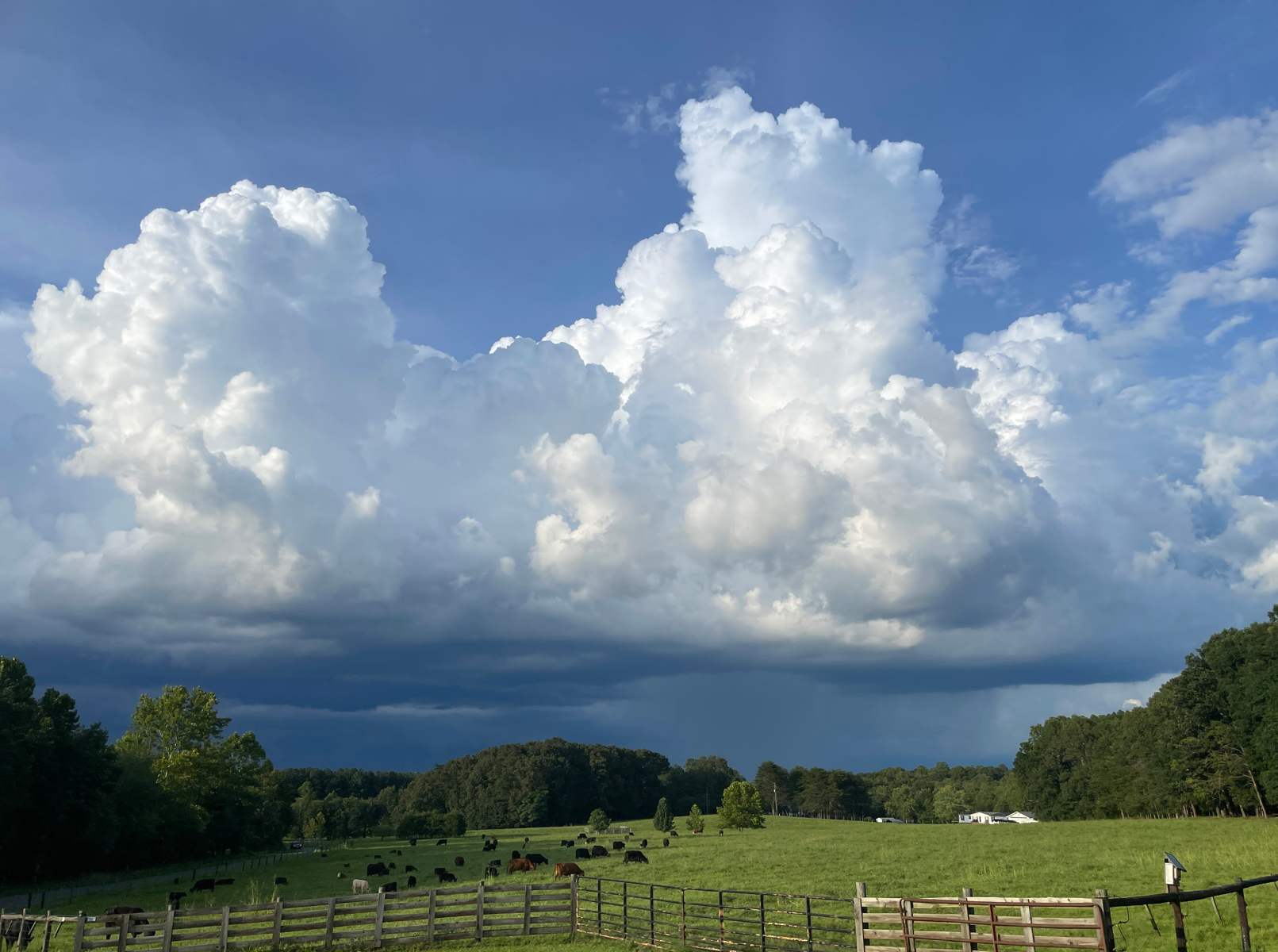 Storm clouds over farm with approaching rain.